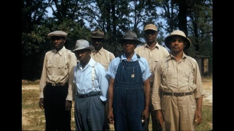 A group of Black men who were participants in the Tuskegee syphilis study, standing outdoors.