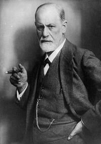 Black-and-white photograph of Sigmund Freud holding a cigar.