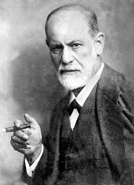 A black-and-white portrait of Sigmund Freud holding a cigar.