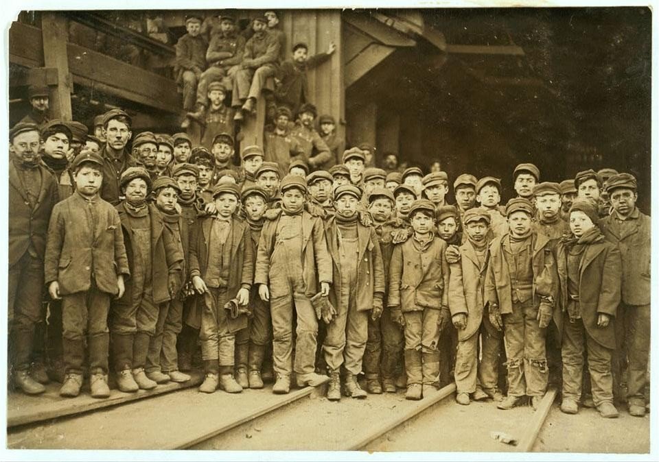 Large group of boys who worked as coal breakers standing outside a colliery in the early 1900s.