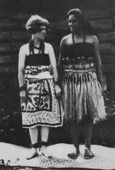 Two young women, one in traditional dress and one in Western dress, standing side by side.